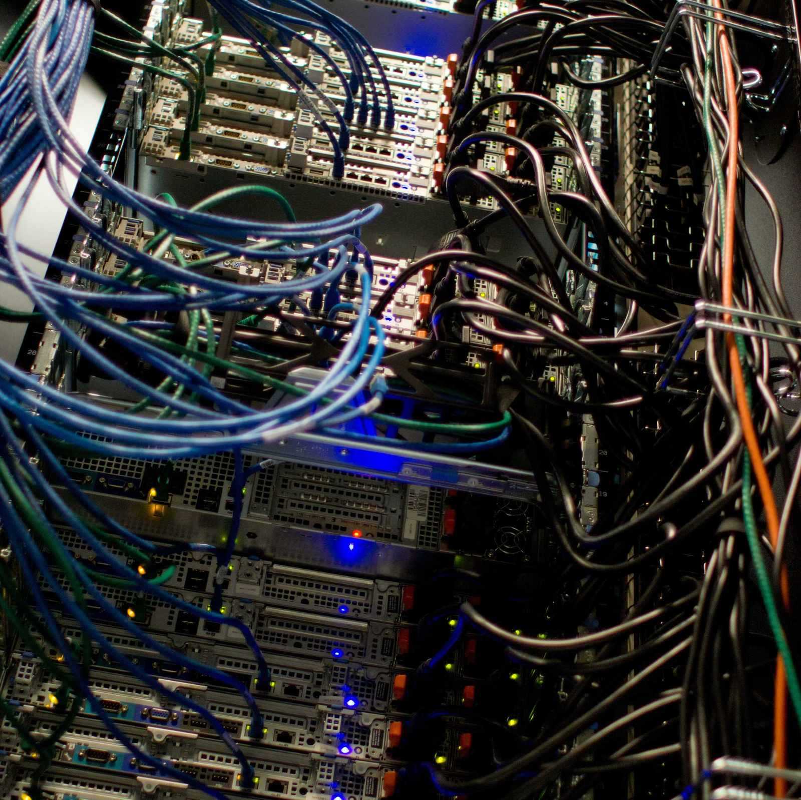 Close view of networked servers with indicator lights in a rack