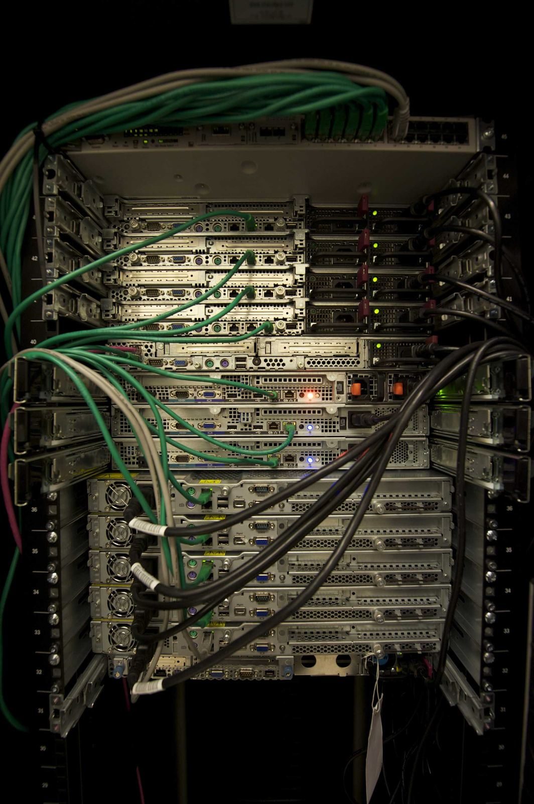 Rows of rack-mounted servers with cabling visible in a data hall